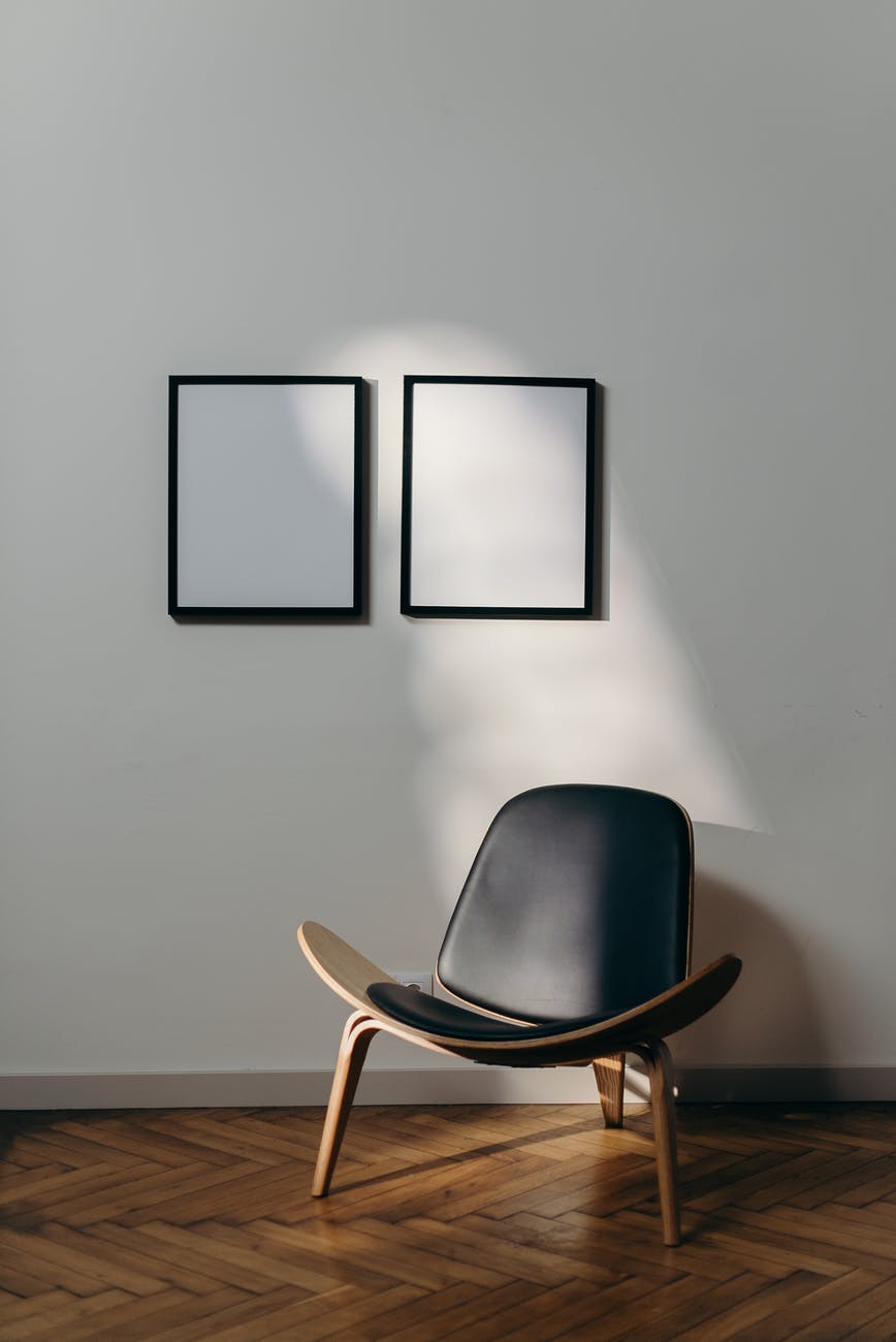 black wooden framed black padded armchair